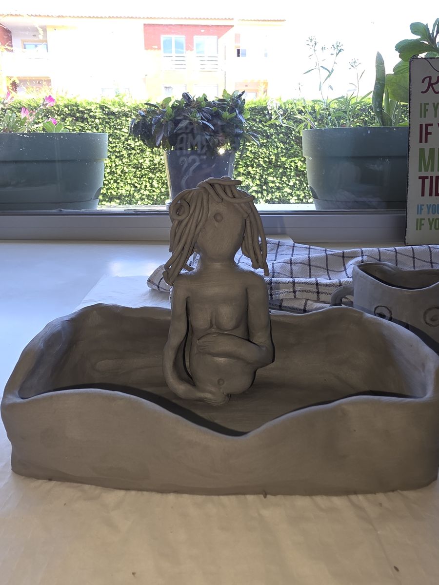 She Holds Herself — raw clay